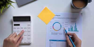 Woman with financial report and calculator.
