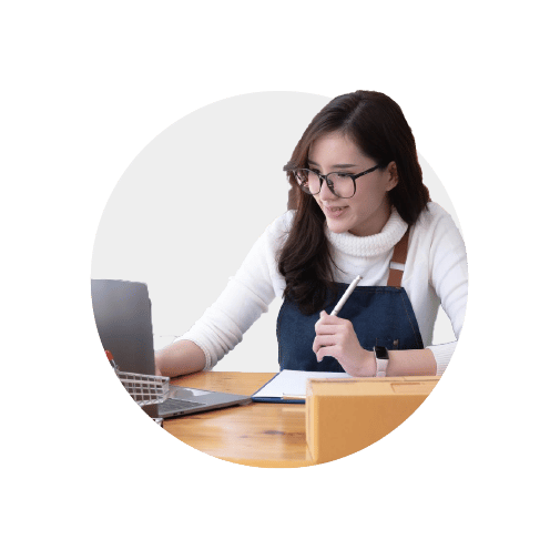 An everyday business owner sat at her laptop, researching guides to cash flow for businesses