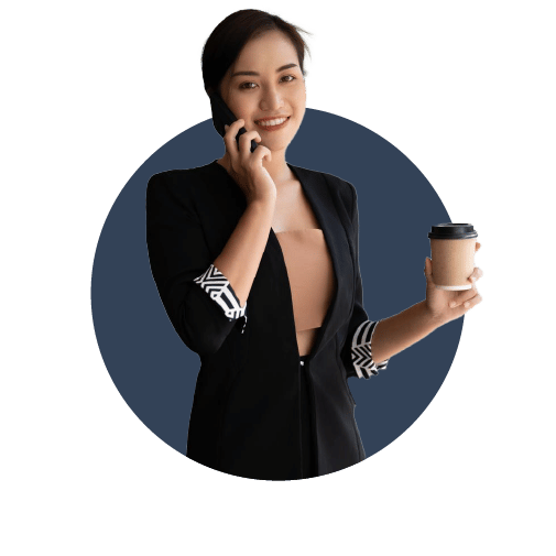 A young female business woman drinking coffee and talking on the phone, having read Go Impartial's Simple Guide To Understanding Business Expenses